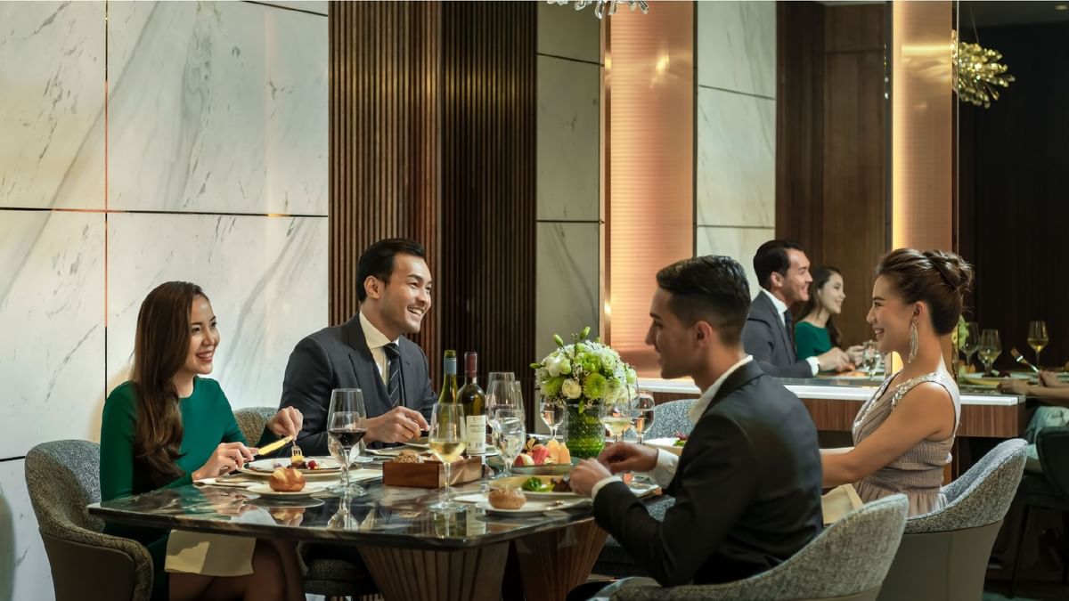 Comfy bed with TV & sitting area in a spacious room at Sunway Resort