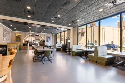 Spacious interior of The Gavel at The Riverwalk Plaza Hotel featuring stylish seating and large windows in a bright setting