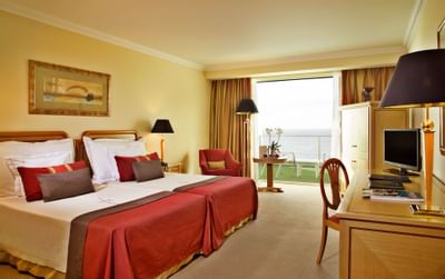 Bedroom with double beds at Hotel Cascais Miragem