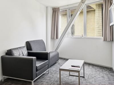 Two couches and a coffee table in a room at Student Living Auckland – Anzac.
