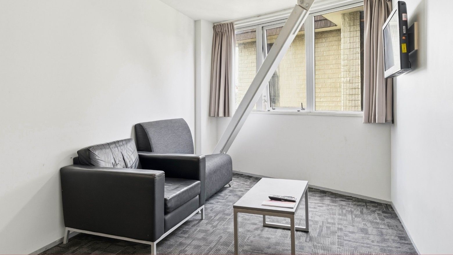 Two couches and a coffee table in a room at Student Living Auckland – Anzac.