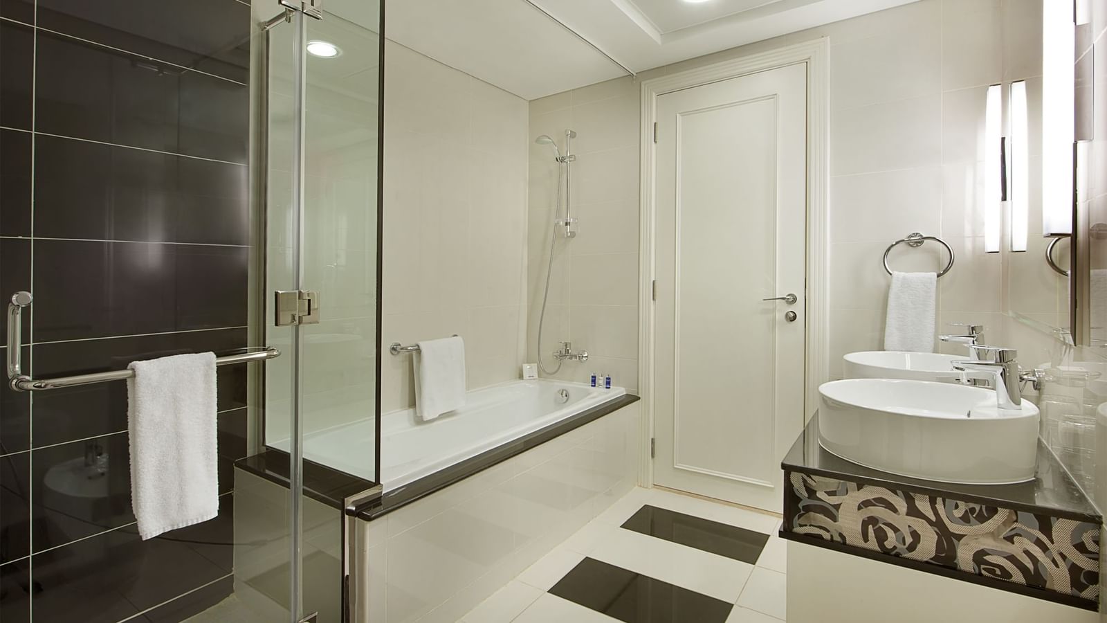 Vanity and shower are with bathtub in Three Bedroom Suite at DAMAC Maison Mall Street