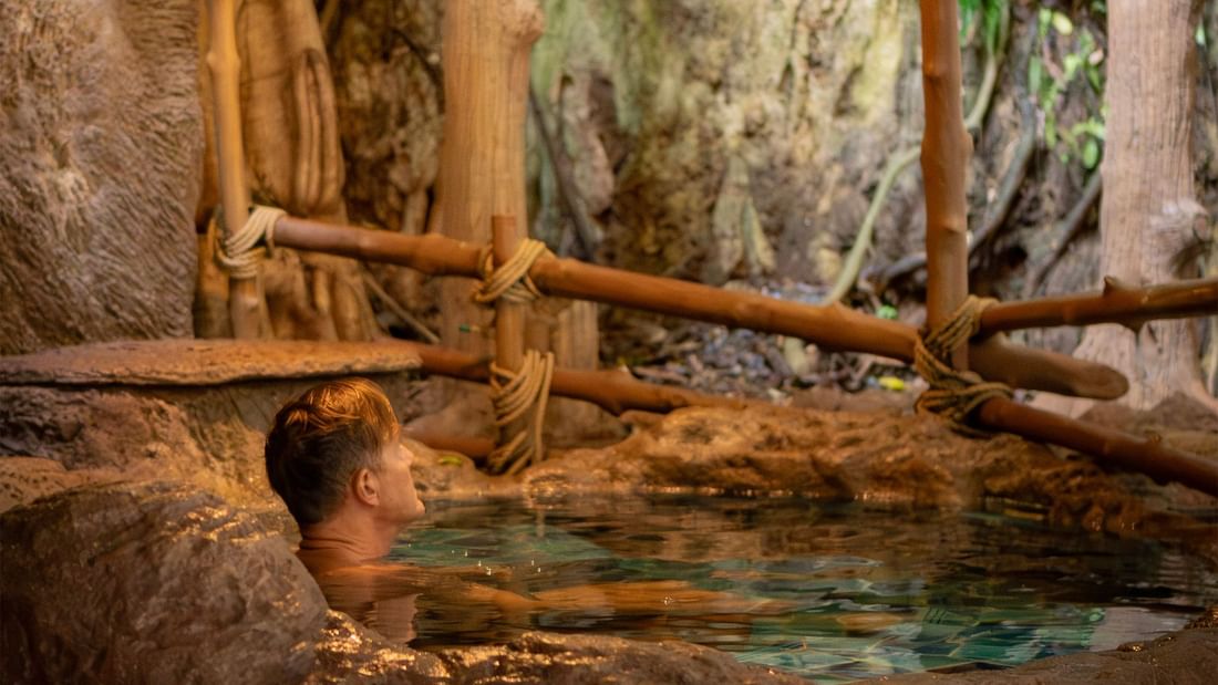 Man resting in an ice bath available at the treatment cave in The Banjaran Hotsprings Retreat
