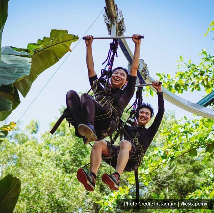 There were two people were enjoying a zip line activity at ESCAPE Penang - Lexis Suites Penang