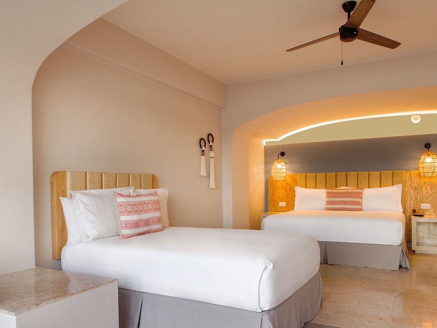 Extra King Bed and Double Bed Deluxe Superior Room with warm lighting and wooden accents at Camino Real Acapulco Diamante