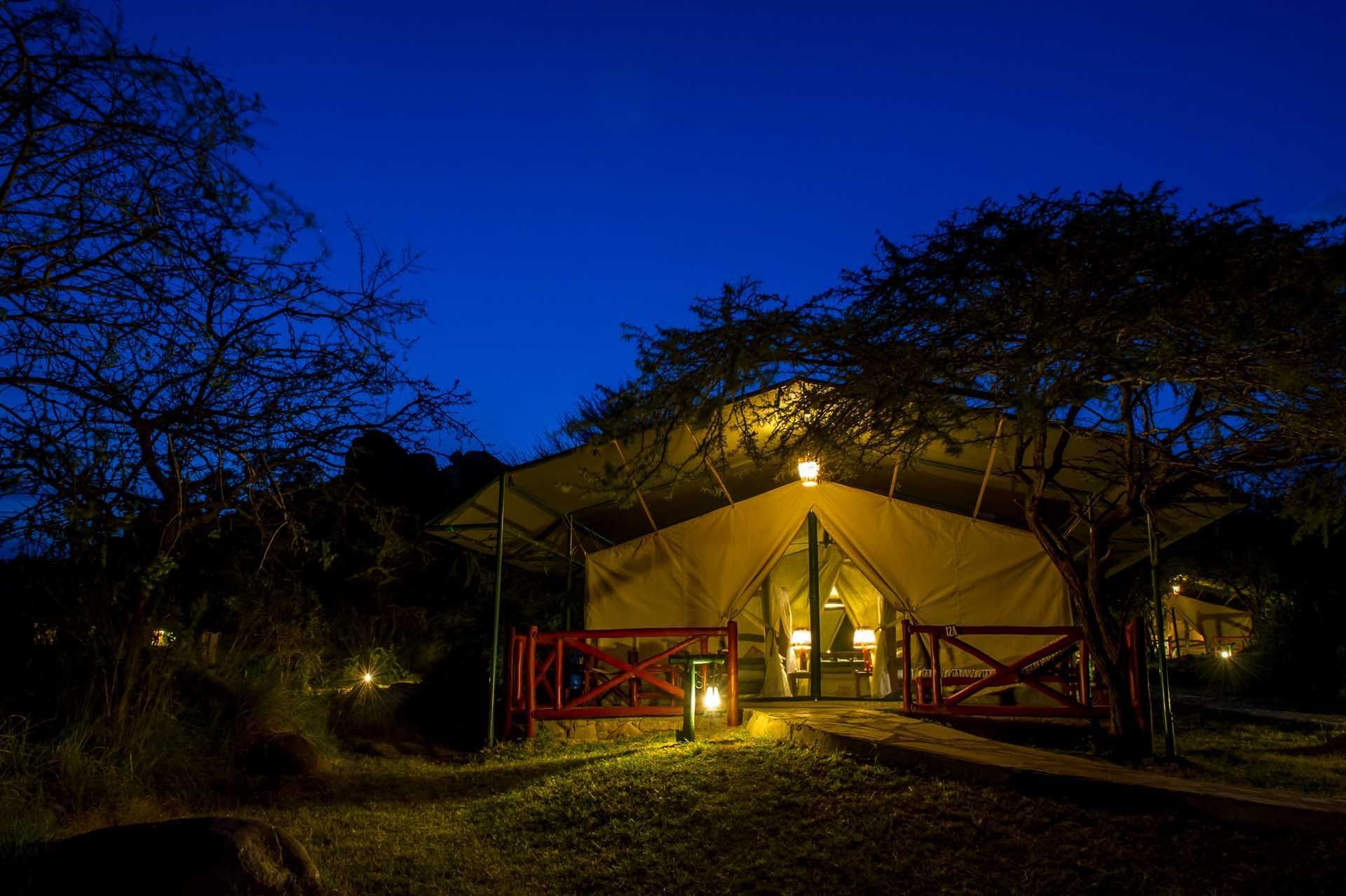 Exterior view of tent at night at Mbuzi Mawe Serena Camp