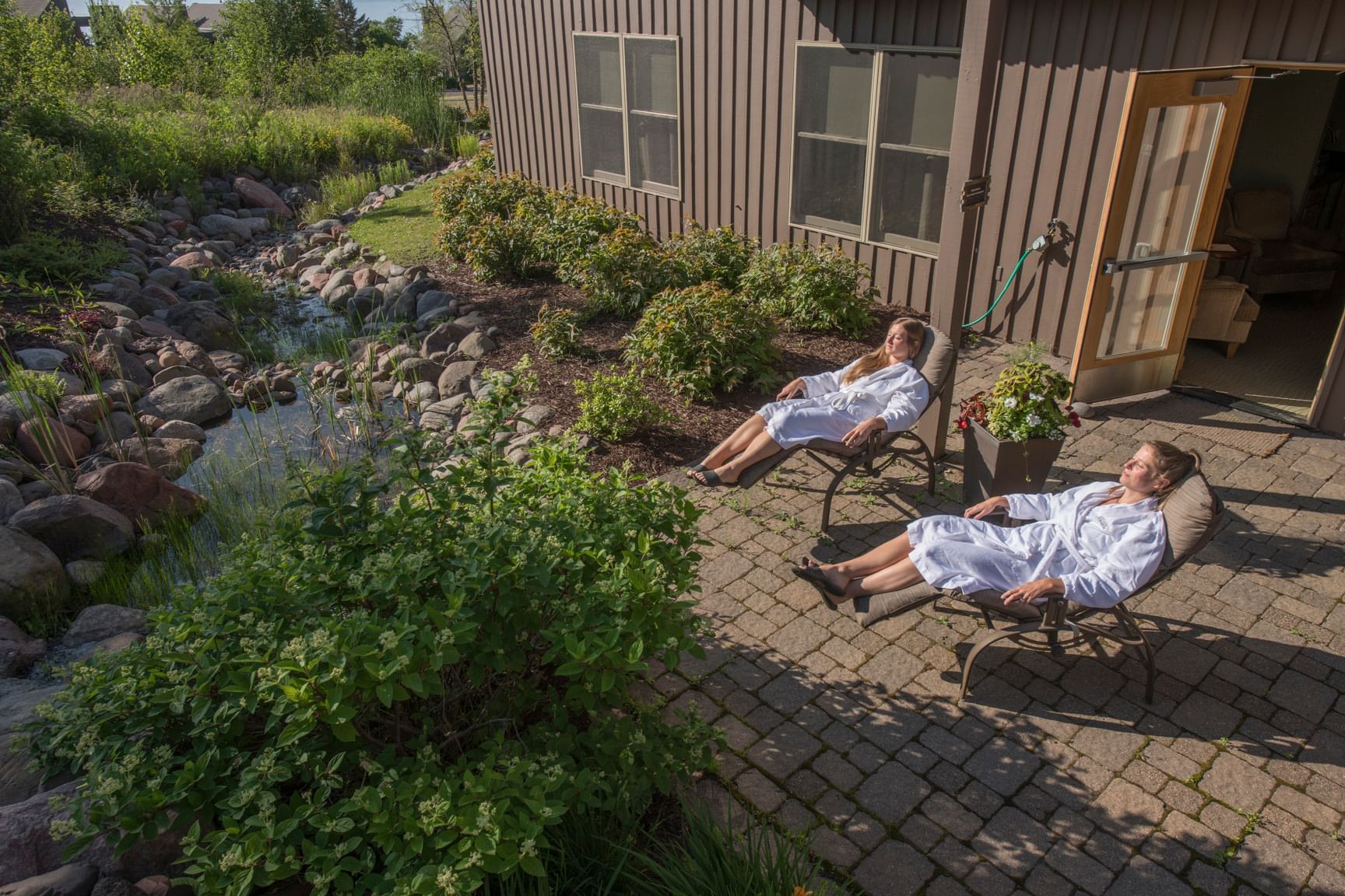 Two ladies in bathrobes relaxing outdoors at Bluefin Bay