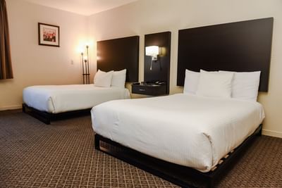 Accessible Double Double Room featuring two queen-sized beds with headboards and soft lighting at Lake Natoma Inn
