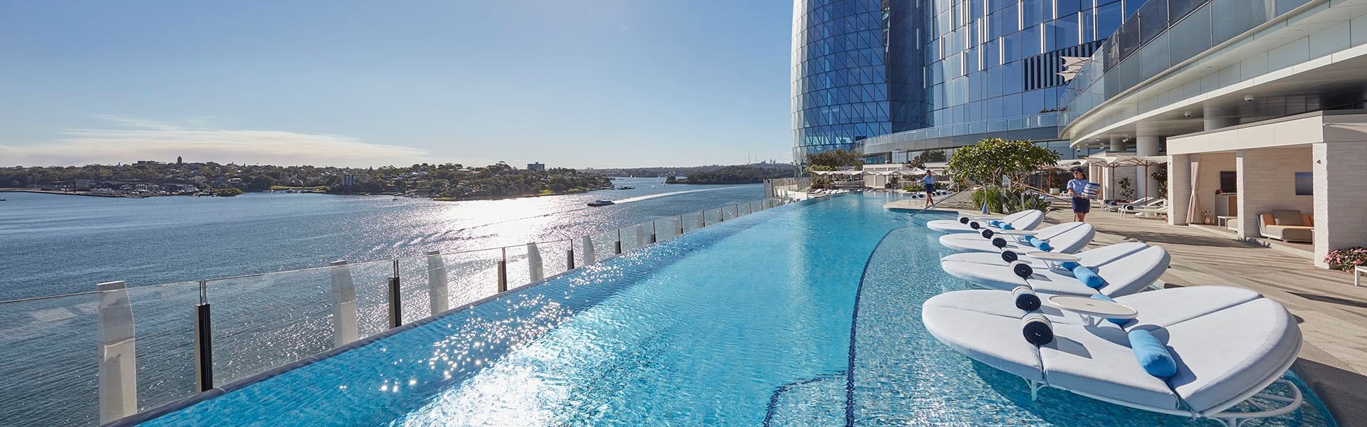 Swimming pool with sun loungers at Crown Towers Perth