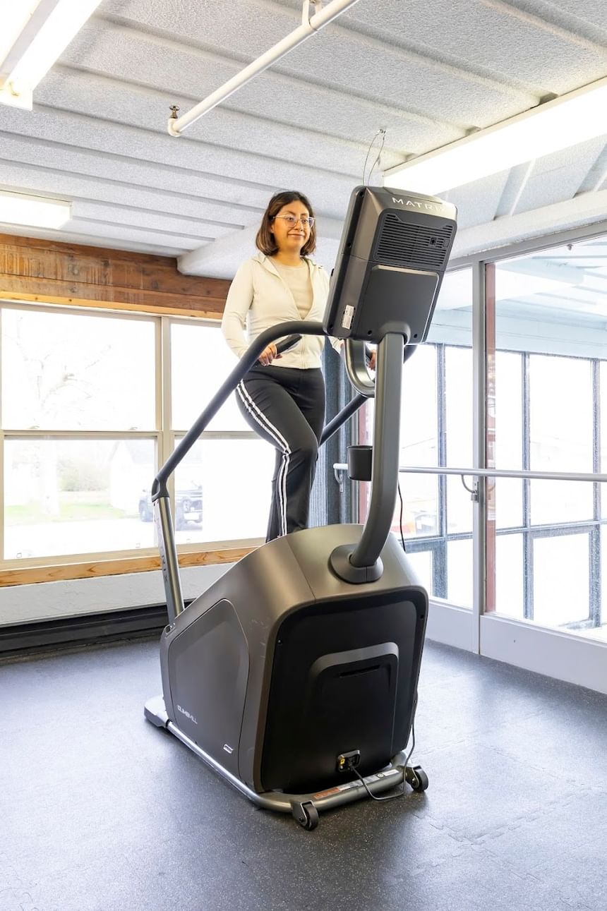 Woman using a cardio machine in the fitness center at Rodd Grand Yarmouth, one of the top hotels with a gym in Yarmouth