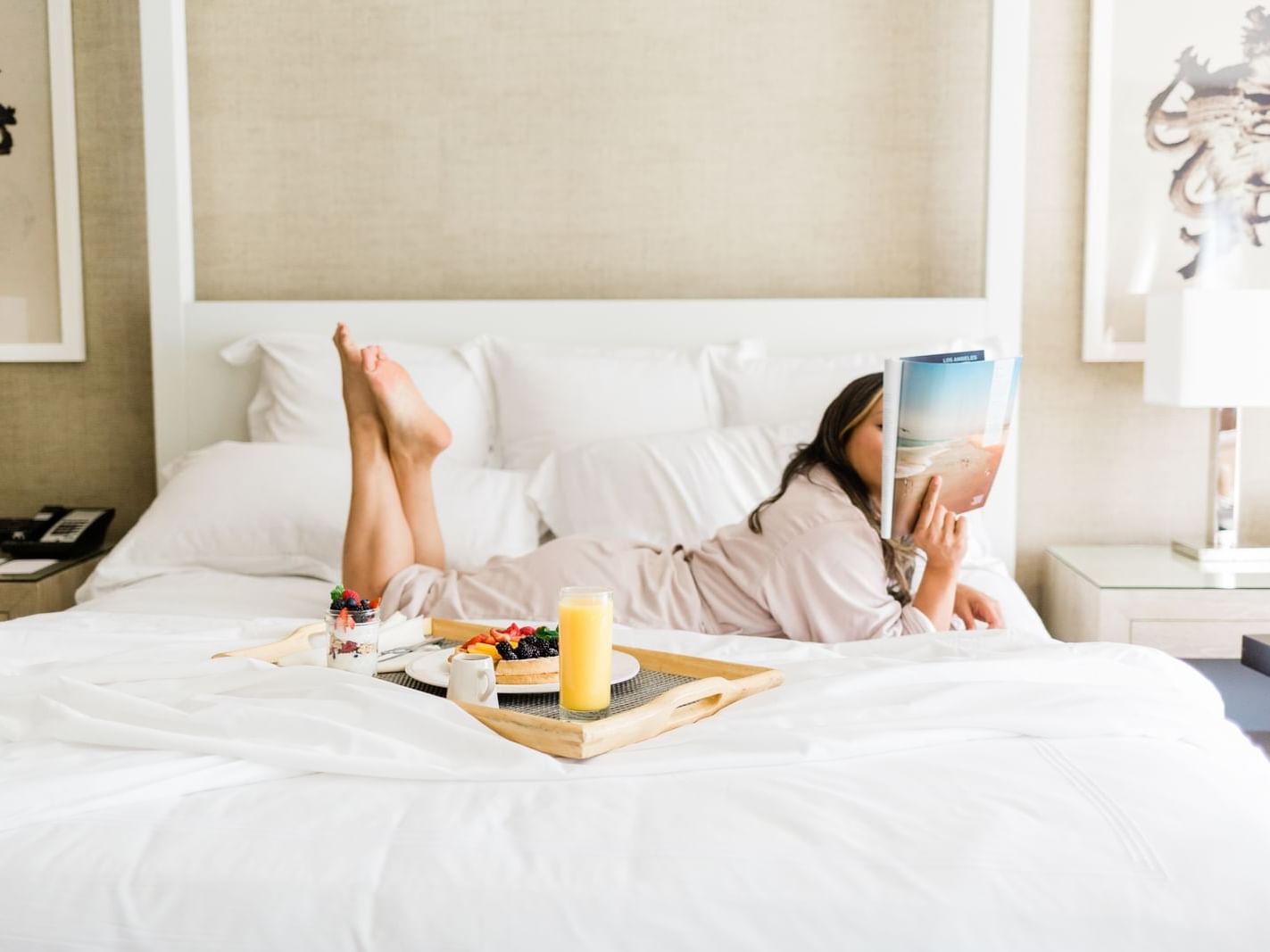 Food Served On Bed To A Woman At Luxe Sunset Boulevard Hotel