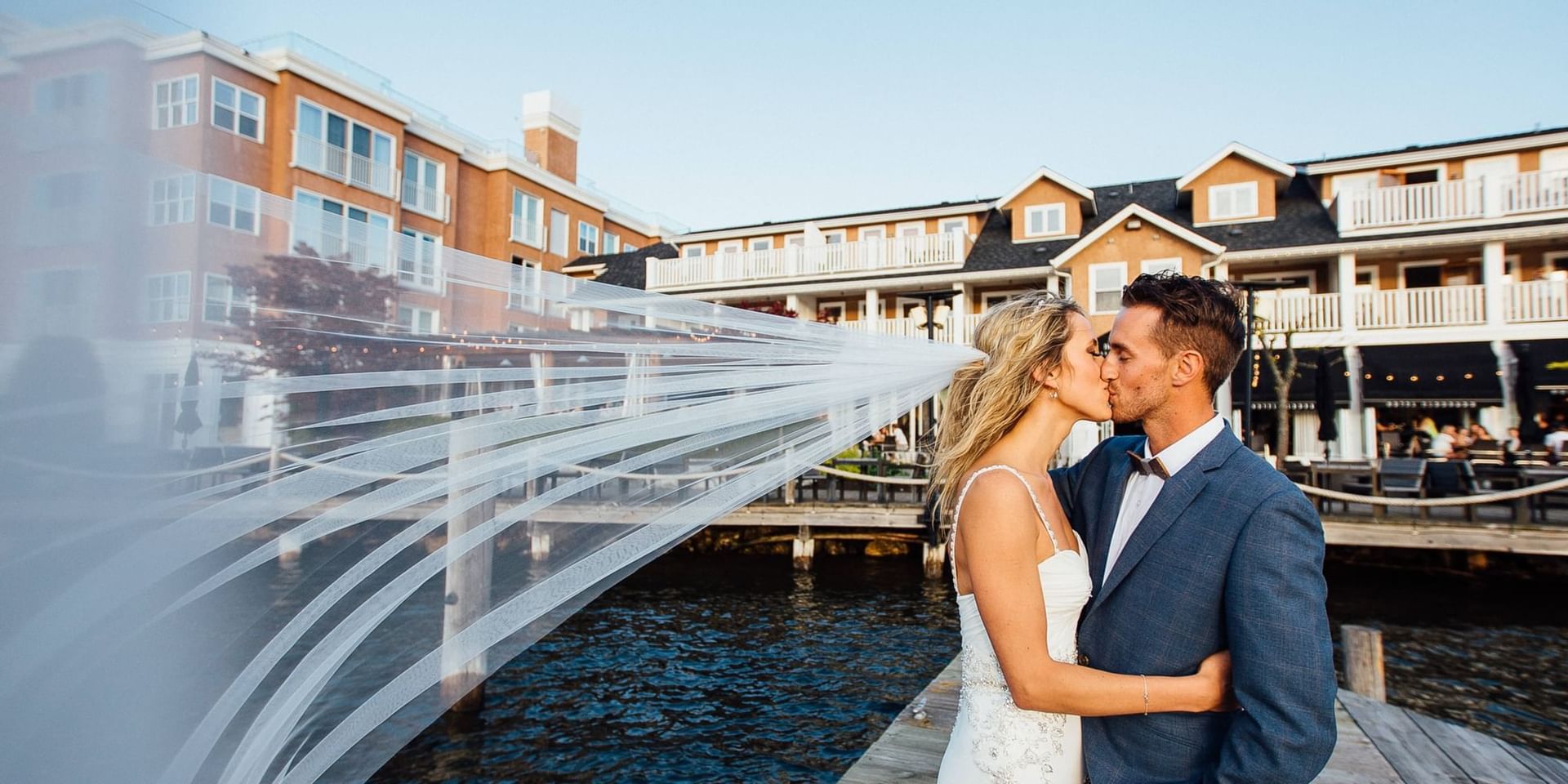 A wedded couple kissing with a hotel view at Hotel Eldorado