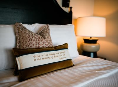 Pillow with a quote on a bed at Alderbrook Resort & Spa