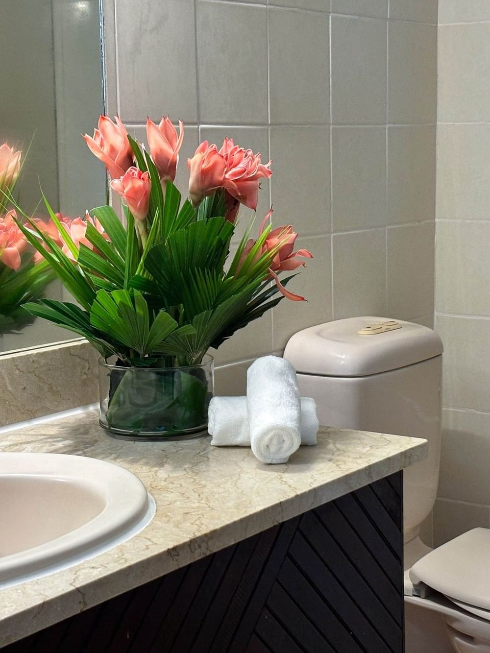 Tranquil bathroom with floral decor and modern fixtures at The Naviti Resort in Korolevu.