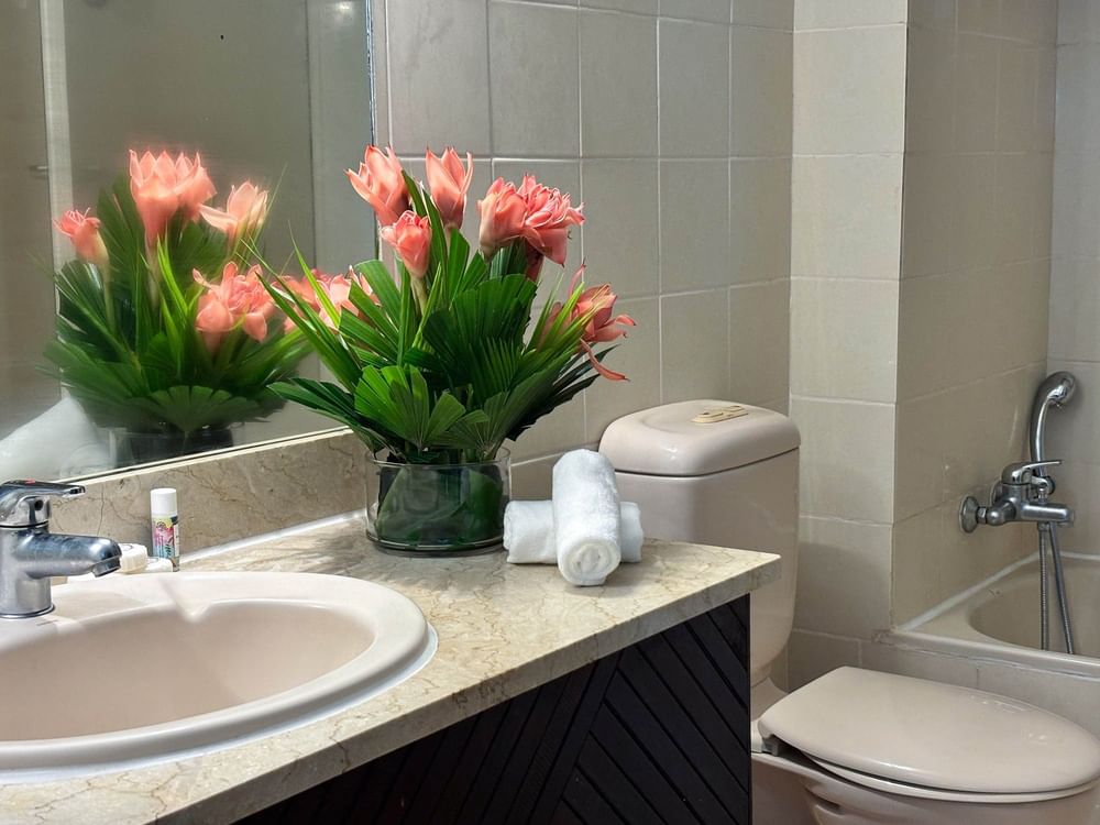 Tranquil bathroom with floral decor and modern fixtures at The Naviti Resort in Korolevu.