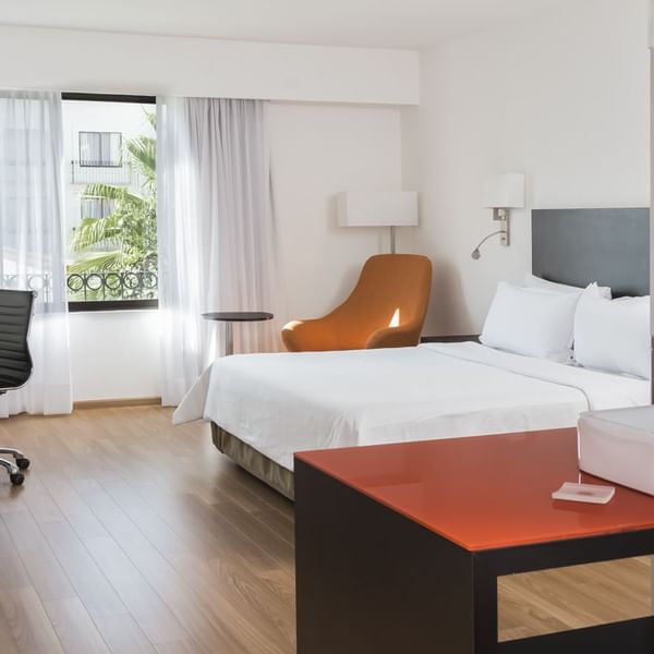 King bed with working desk in Superior Room at Fiesta Inn