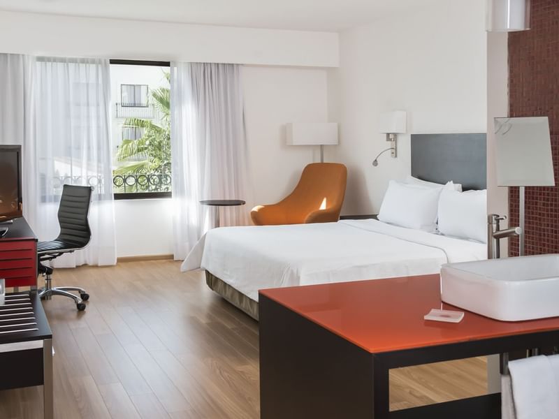 King bed with working desk in Superior Room at Fiesta Inn