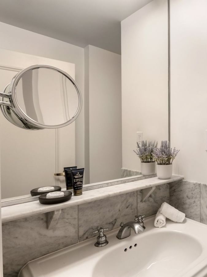 Premium Suite Two Queen Beds bathroom featuring a vanity with a mirror and a glass shower at Warwick Allerton Chicago