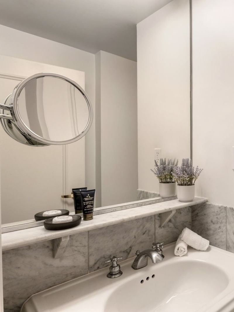 Premium Suite Two Queen Beds bathroom featuring a vanity with a mirror and a glass shower at Warwick Allerton Chicago