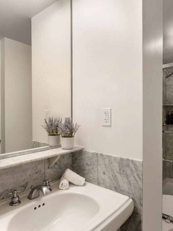 Two Queen Beds bathroom featuring a vanity with a mirror and a glass shower at Warwick Allerton Chicago
