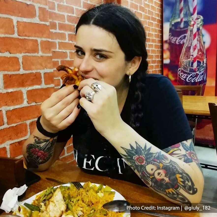 a female tourist was enjoying her nasi kandar at Hameediyah Restaurant