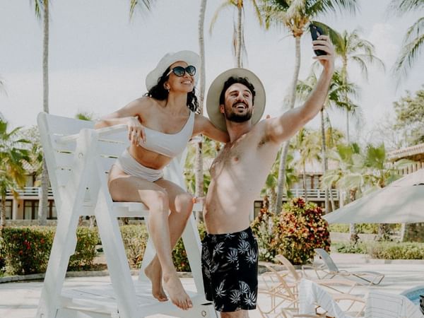 A couple taking a selfie by the pool area in Pierre Mundo Imperial