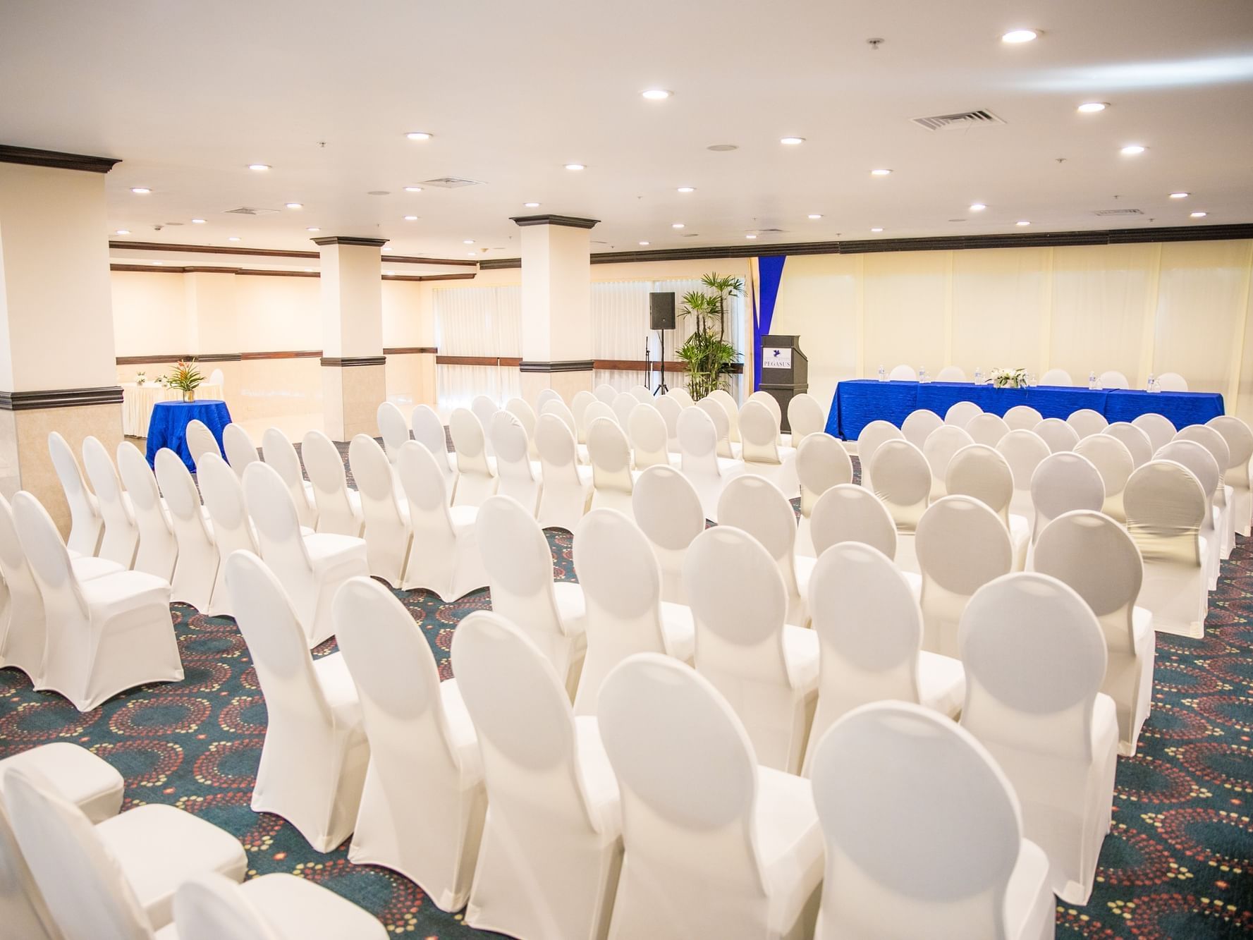 Theatre set-up with white chairs in Talk of the Town at Jamaica Pegasus Hotel