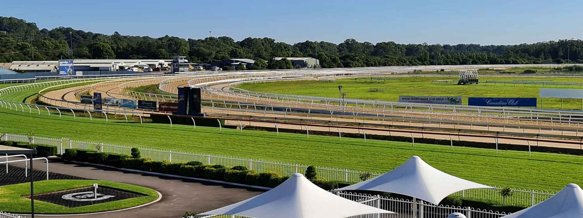 Wyong Race Course view with track, white tents, and seating areas near Mercure Kooindah Waters