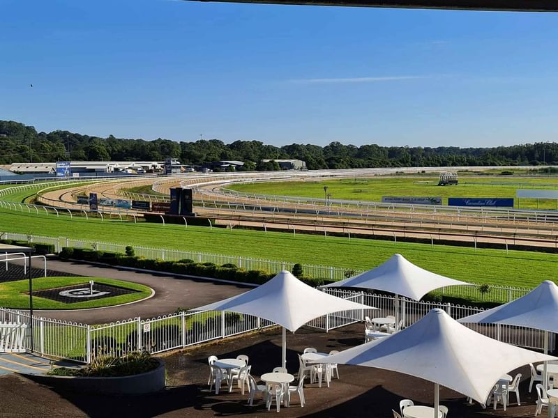 Wyong Race Course view with track, white tents, and seating areas near Mercure Kooindah Waters