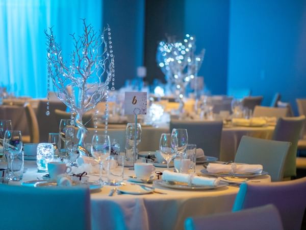 Banquet tables with wedding décor at Warwick Le Crystal