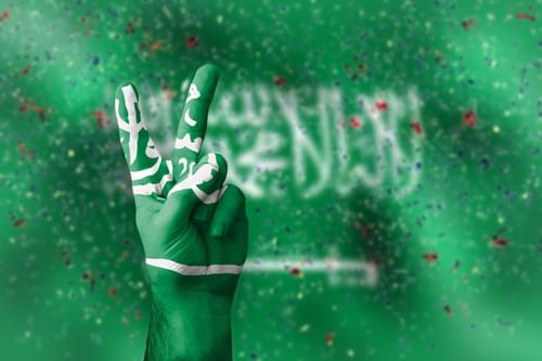 A hand-painted Saudi Arabian flag shows a peace sign against a green backdrop at Saja Warwick Madinah
