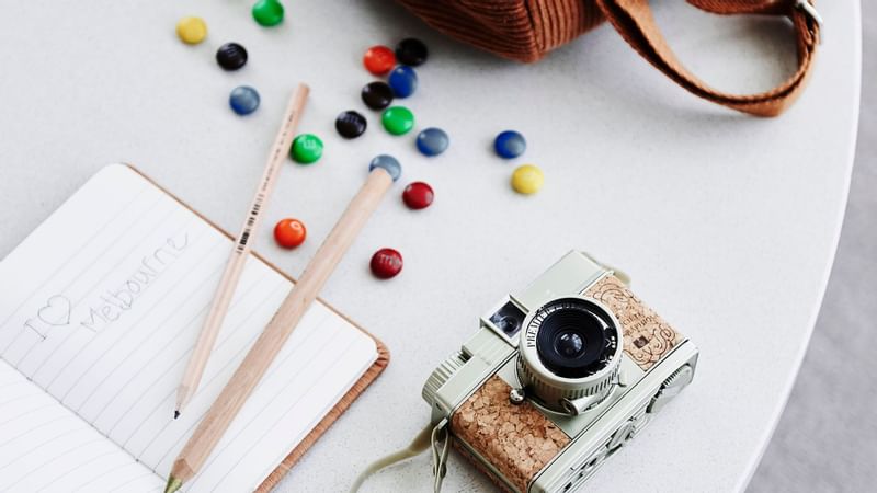 Camera & book on a table in MiniBar at Crown Hotels Group