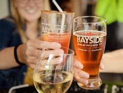 Closeup of beer toasting at Bayside Brewing near Retro Suites