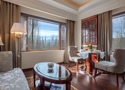 The Indus Valley Suite living room area with a view & wooden floors at The Indus Valley Leh, Hotel Stay in Leh