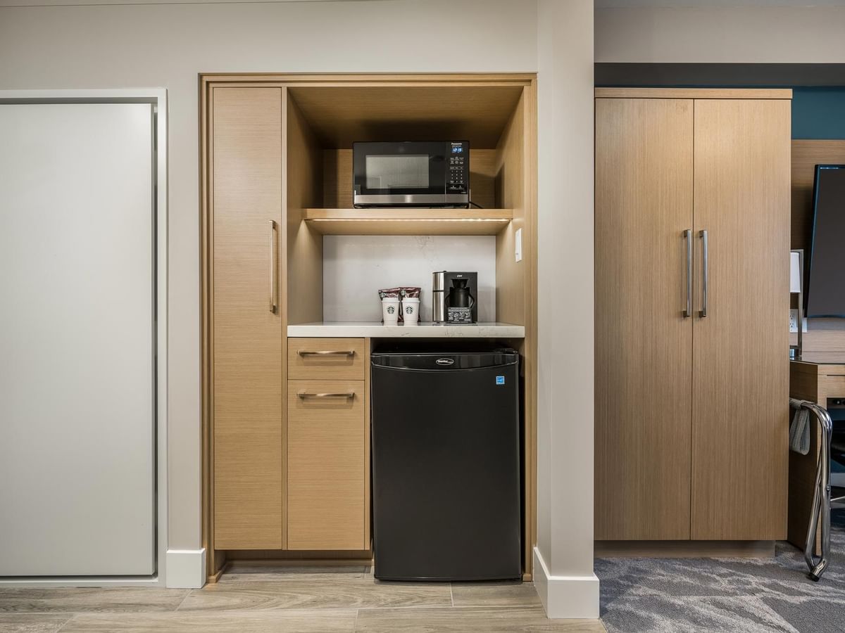 View of the kitchenette area, featuring microwave, coffee machine and mini fridge