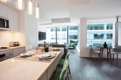 Kitchen & living room with a dining table at ReStays Ottawa