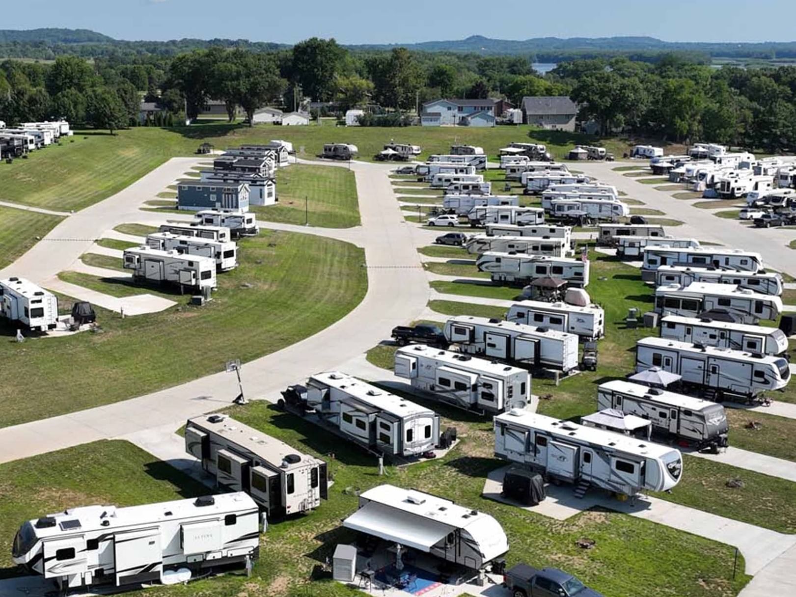 View of a spacious RV park with numerous parked trailers and vehicles from Non Riverfront Site at Off Shore Resort