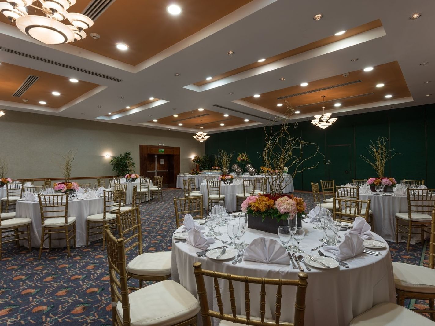 Floral banquet tables set-up in Rosehall Ballroom with carpeted floors at Holiday Inn Montego Bay