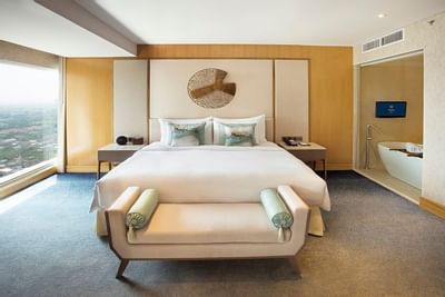 Glacier Suite with king bed & sofa at Vasa Hotel Surabaya