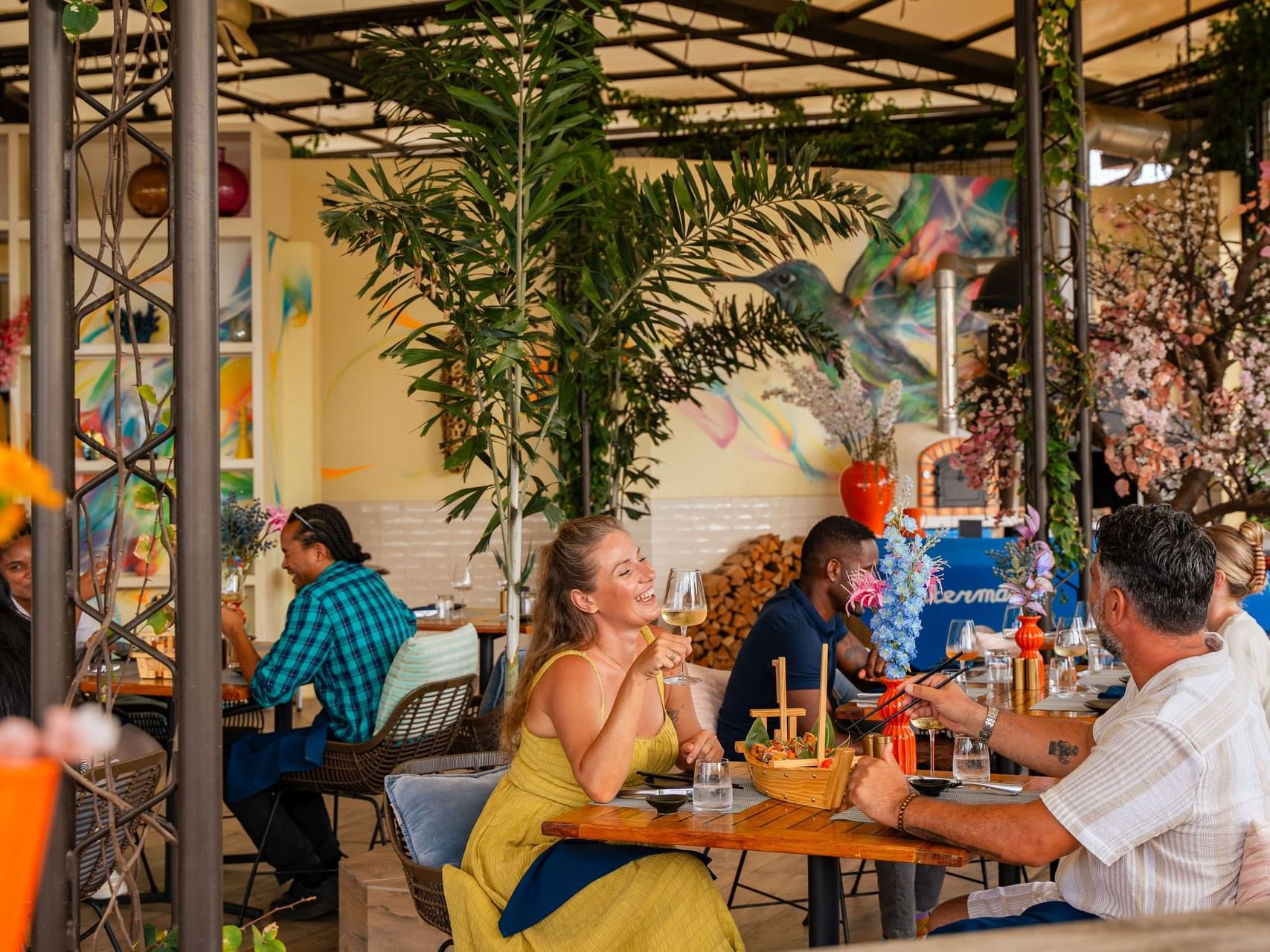 Bobbie's Beach Club met gasten die genieten van maaltijden omringd door planten en decoraties in Golden Rock Resort