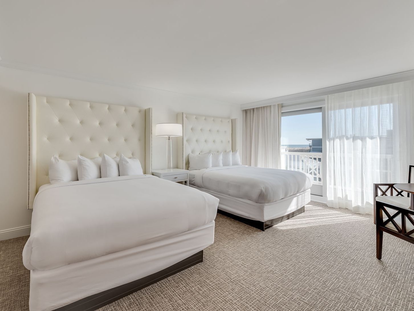 room with two all white beds