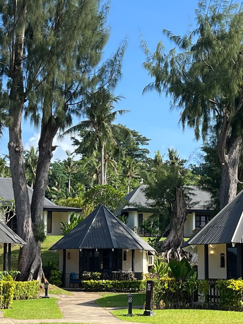Garden Bungalows surrounded by lush greenery and palm trees at Warwick Le Lagon - Vanuatu in Efate.