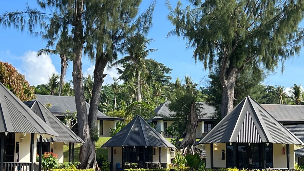Garden Bungalows surrounded by lush greenery and palm trees at Warwick Le Lagon - Vanuatu in Efate.