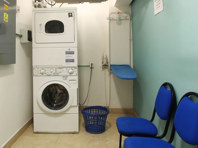 Washing machine, dryer & chairs in Laundry Room at One Hotels