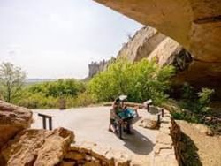 People at Pictograph Cave State Park on a sunny day near Boothill Inn & Suites