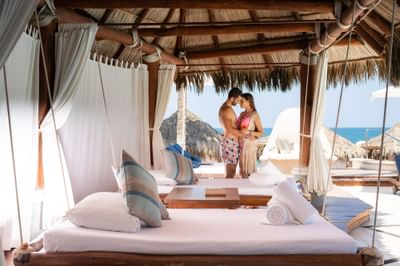 Couple in a Beach cabana with a daybed near Villa Premiere Boutique Hotel & Romantic Getaway