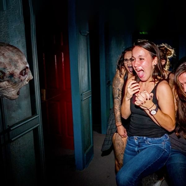 People reacting to a scare in Halloween Horror Nights at Lake Buena Vista Resort Village & Spa