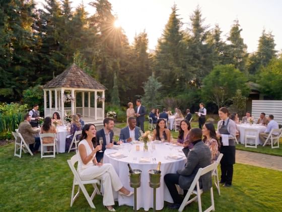 Guests dining by tables at Oregon Garden Resort, one of the best places to stay in Silverton
