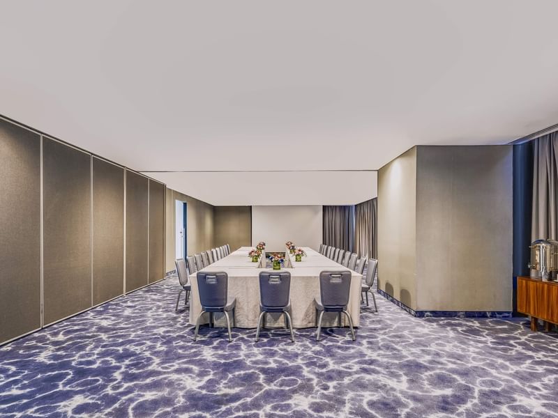 Long dining table set up in meeting room with chairs at Live Aqua Monterrey.