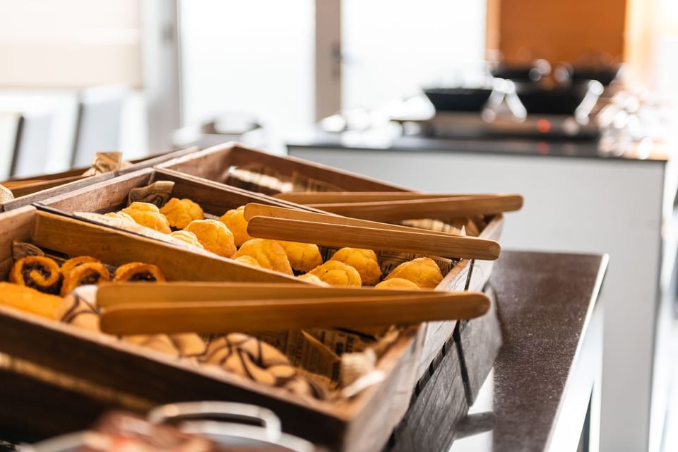 Baked goods with tongs in the buffet in the restaurant at Hotel Vila Centric